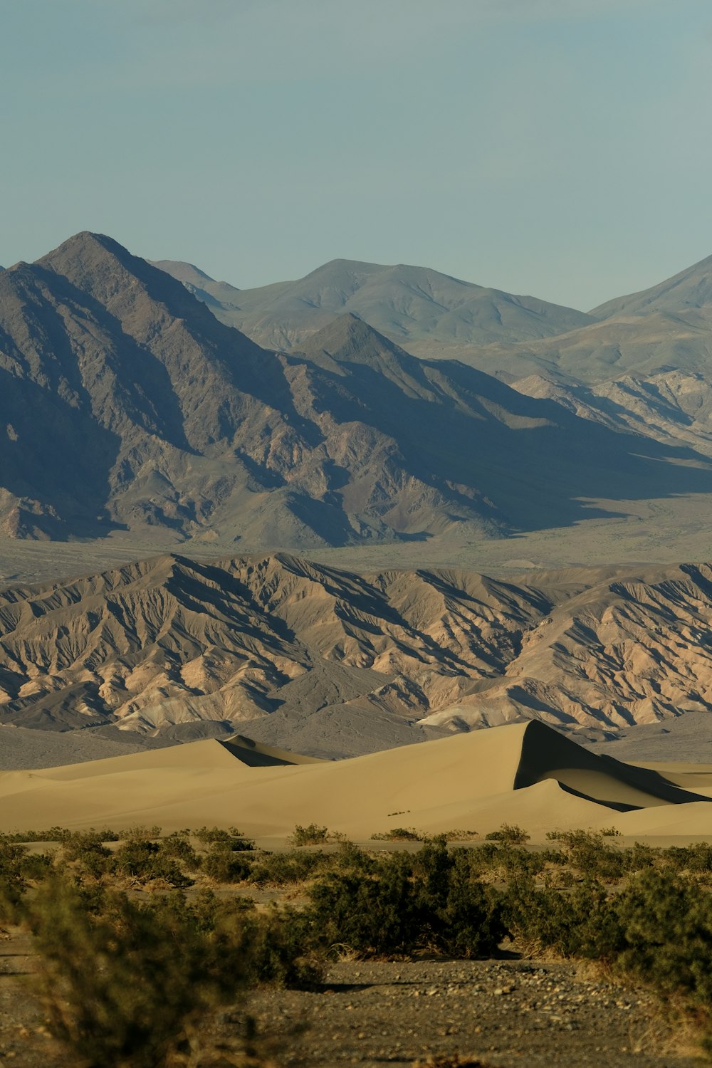 a desert landscape with mountains in the background