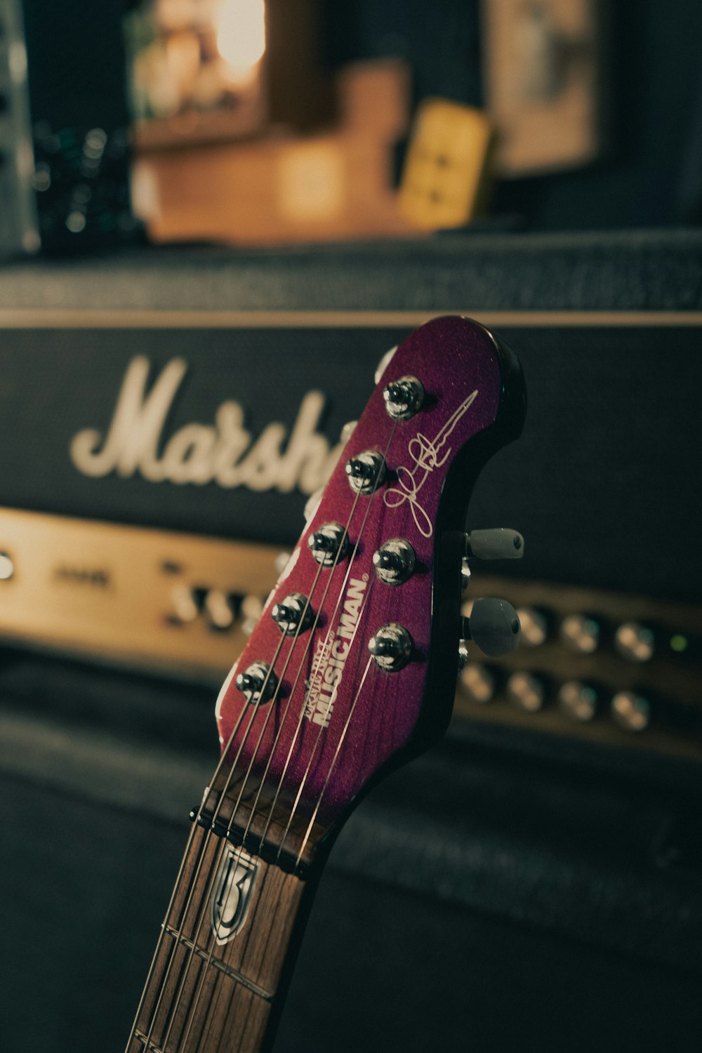 a close up of a guitar head and amp