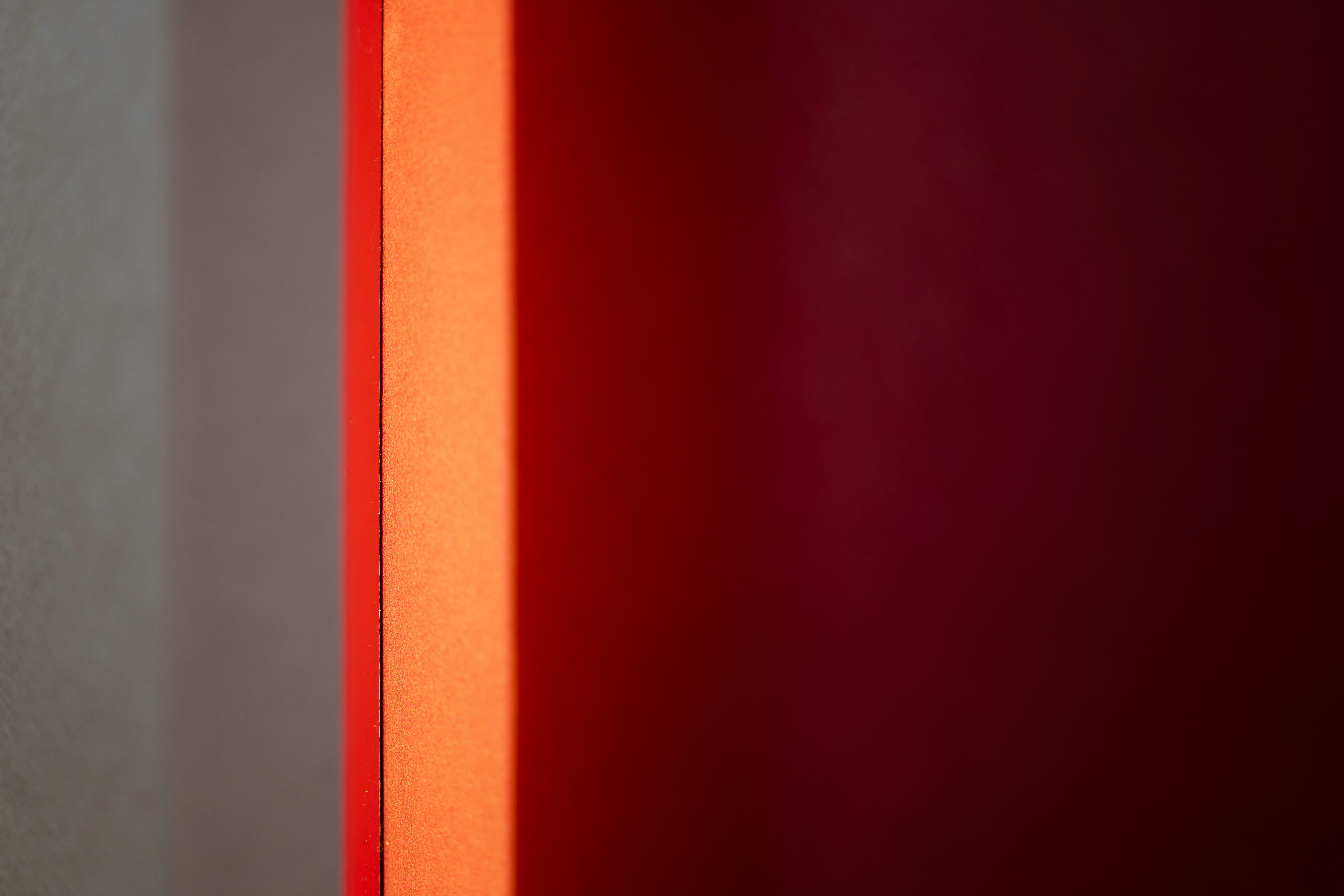 a red light shining through a window in a room