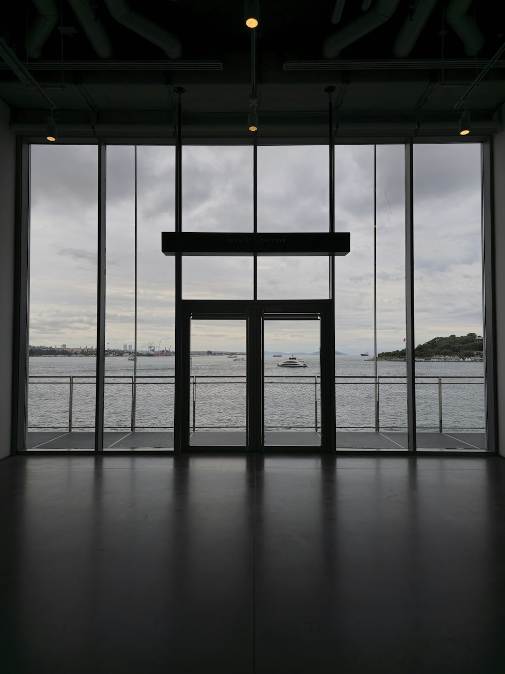 an empty room with a view of a body of water