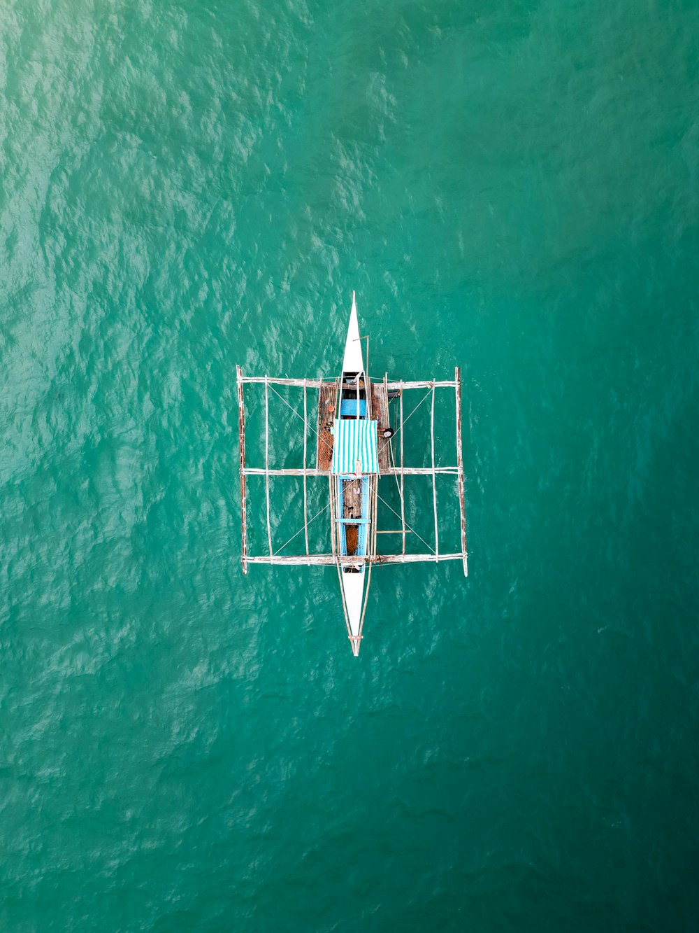 a person in a boat in the middle of the ocean