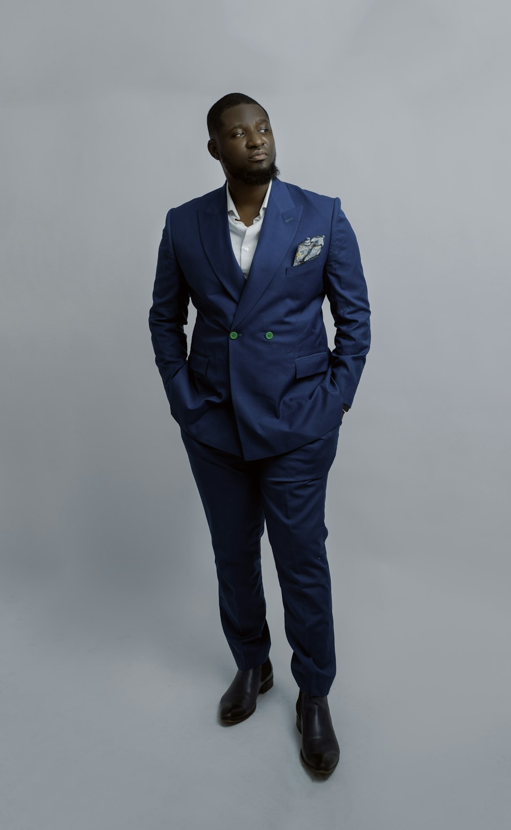 a man in a blue suit posing for a picture