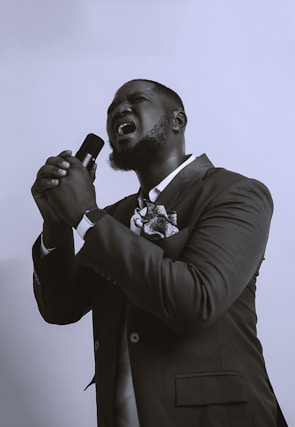 a man in a suit singing into a microphone