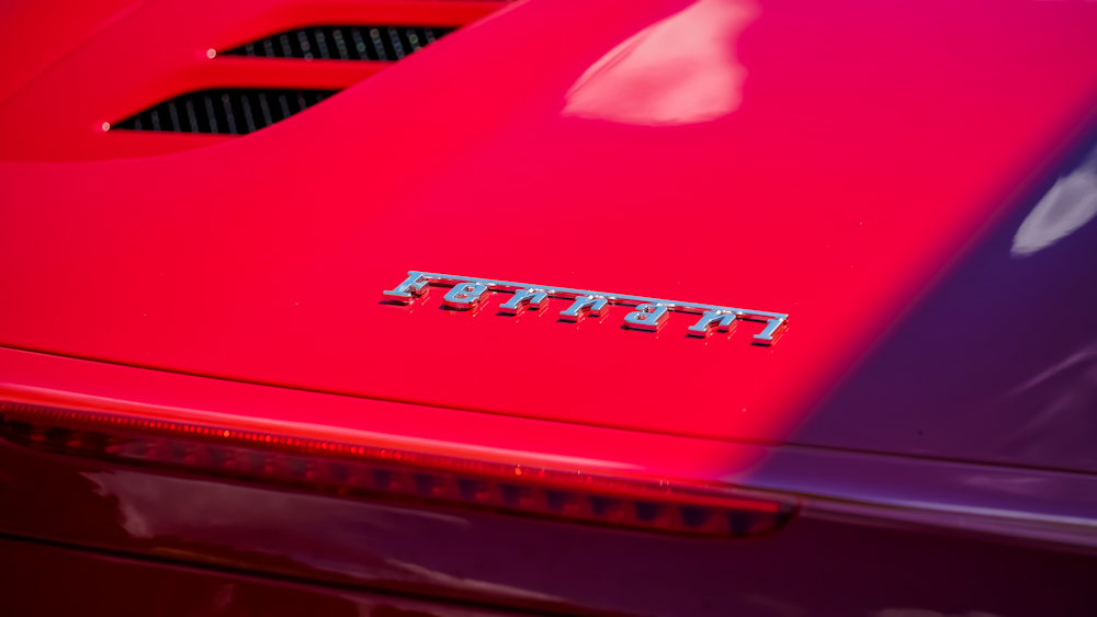 um close up do capô de um carro esportivo vermelho