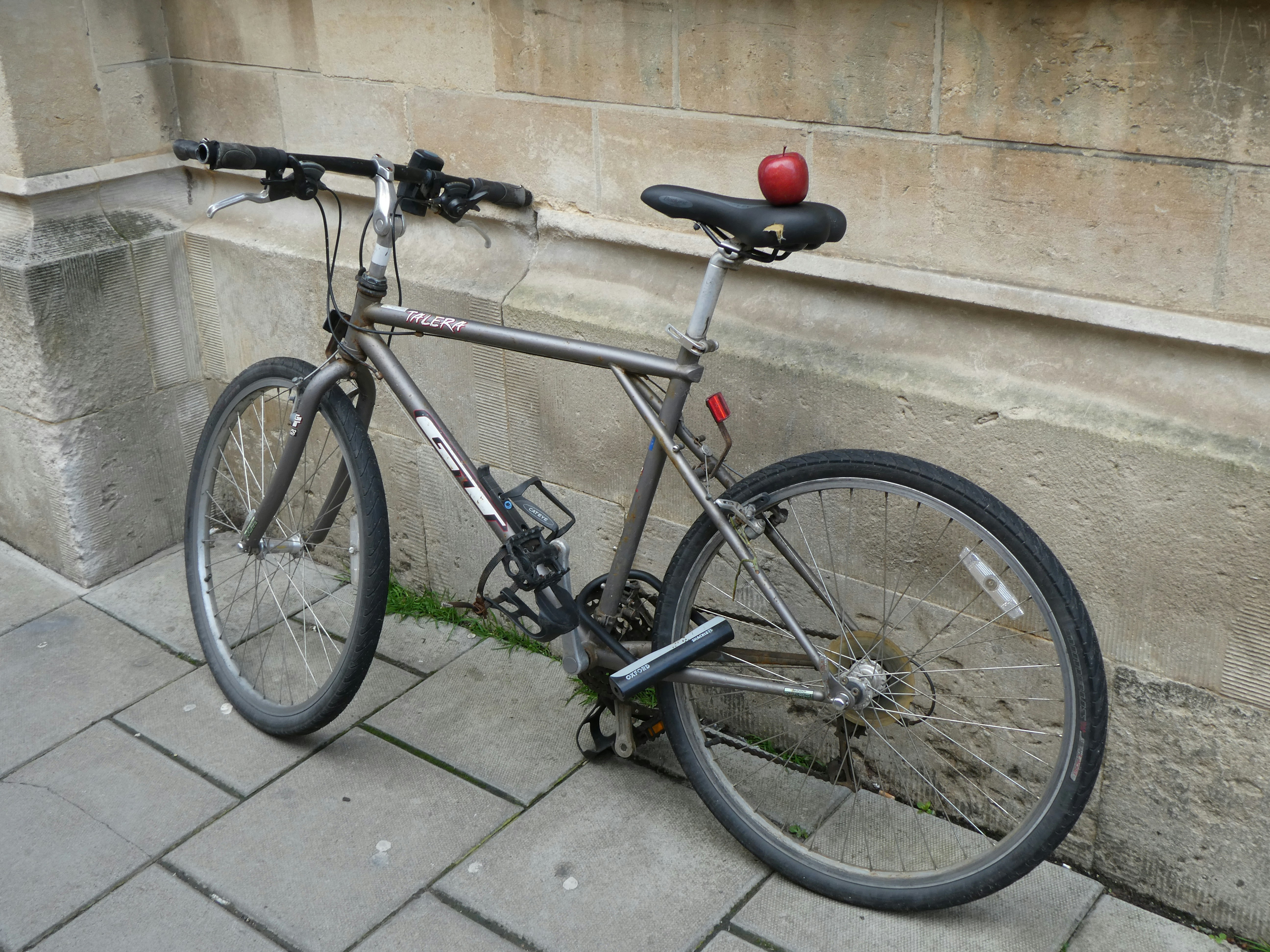 a bicycle parked on the side of a building
