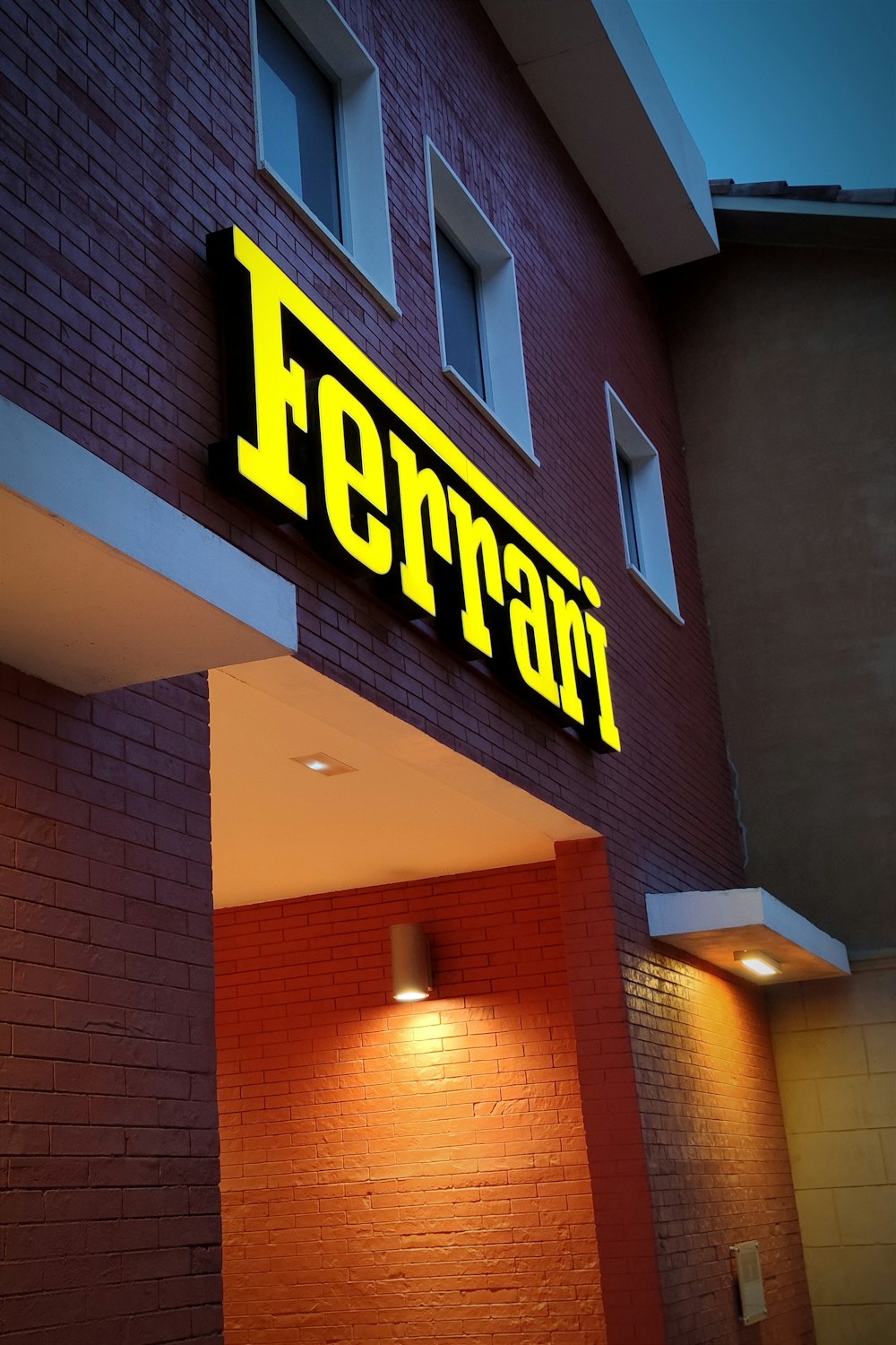 the front of a building with a neon sign on it