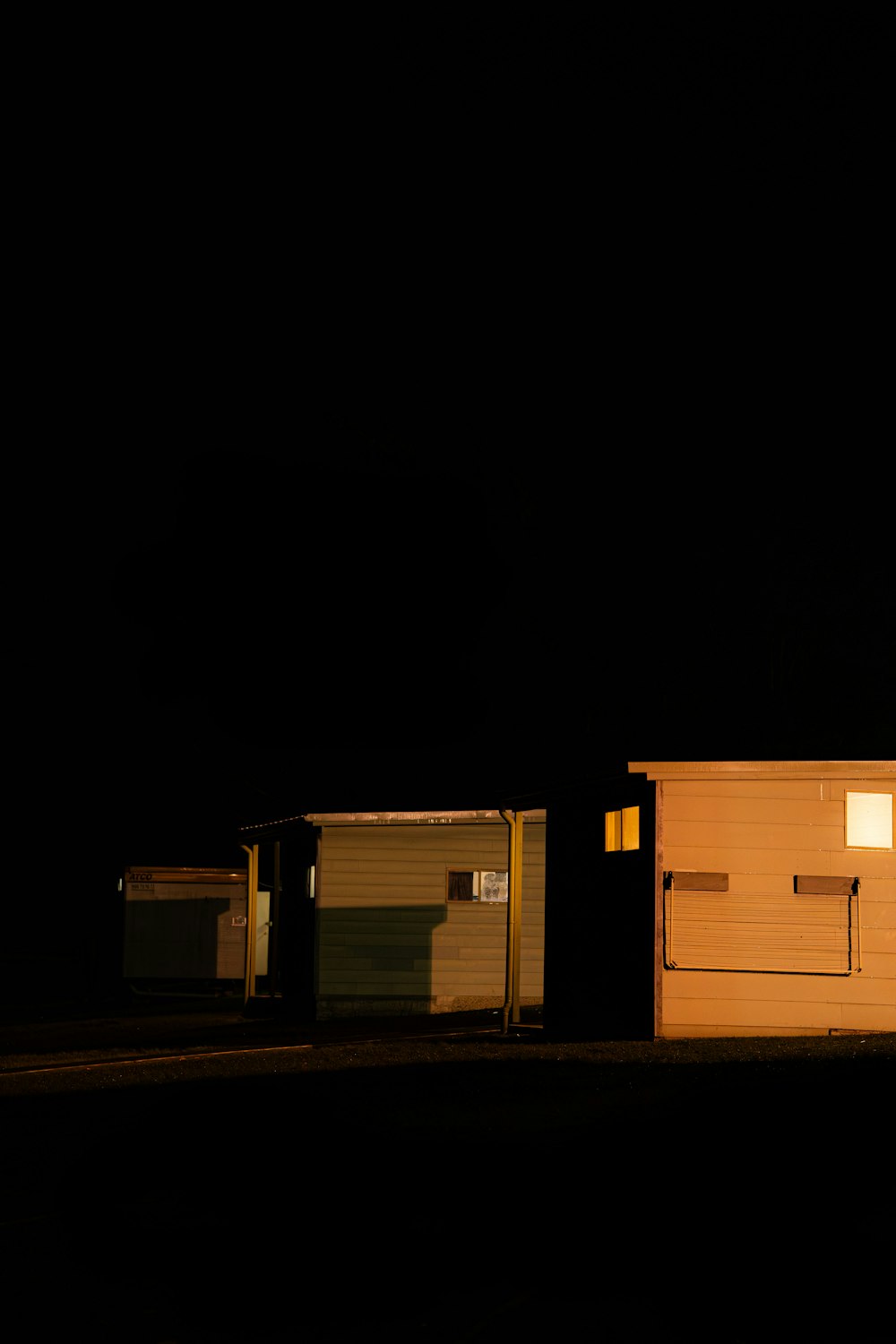 a couple of garages sitting next to each other in the dark