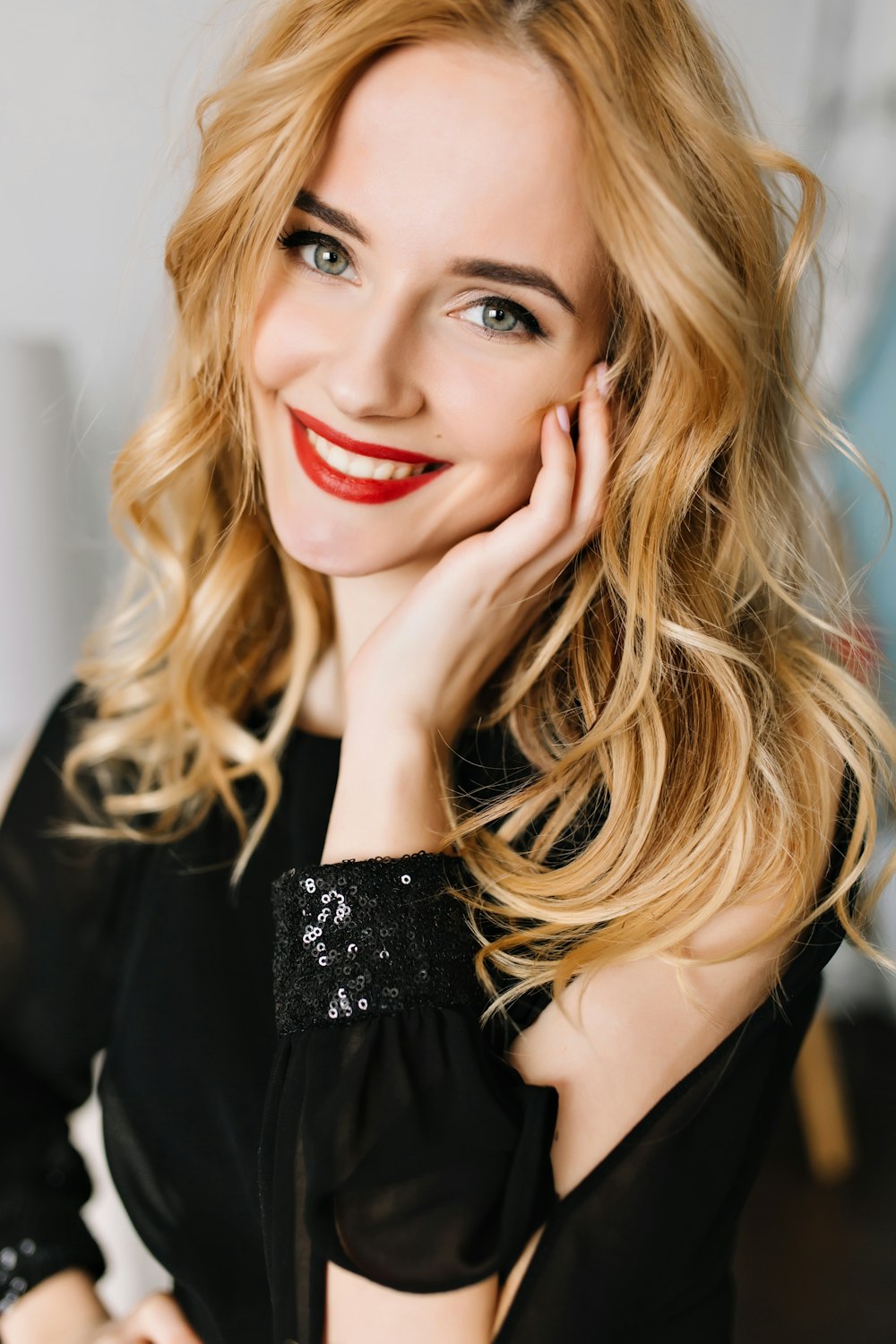 a woman with long blonde hair wearing a black dress