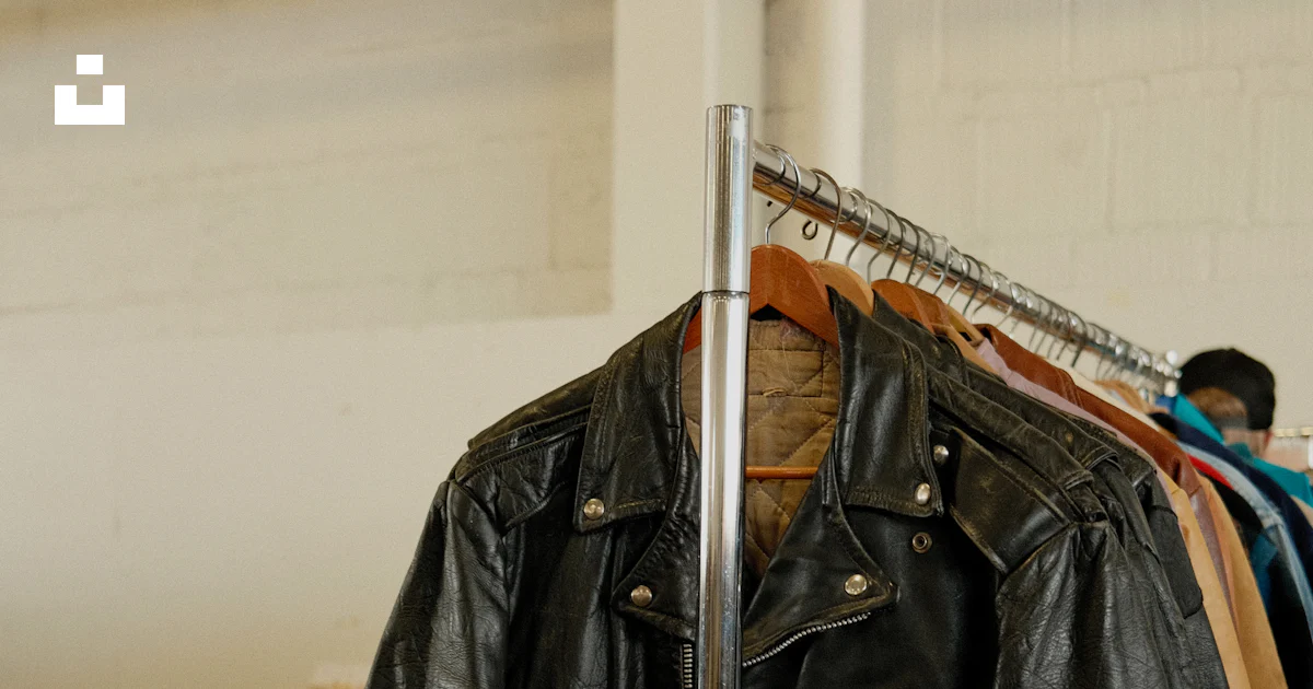 Jacket Hanging On Rack A black leather jacket hanging on a clothes rack photo – Free Film ...