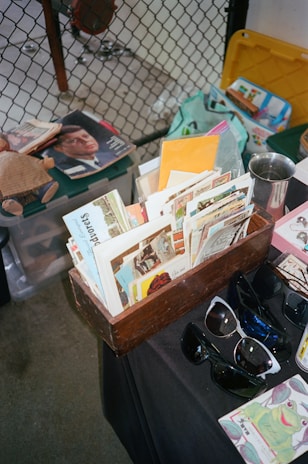 A collection of historical 3D stereoscopic cards displayed on a wooden table.