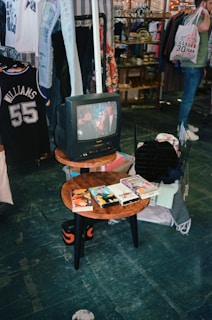 a television sitting on top of a wooden table