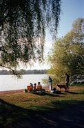 Group of club members with their dogs by the lake preparing for a demonstration.