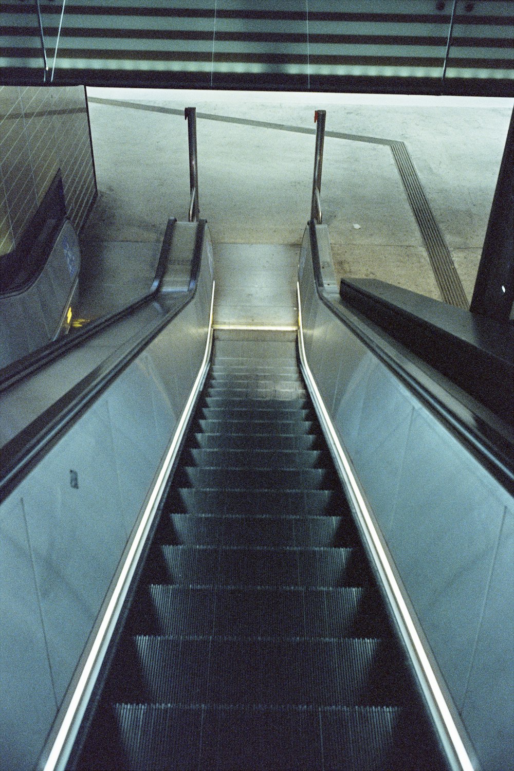an escalator in a subway station with stairs