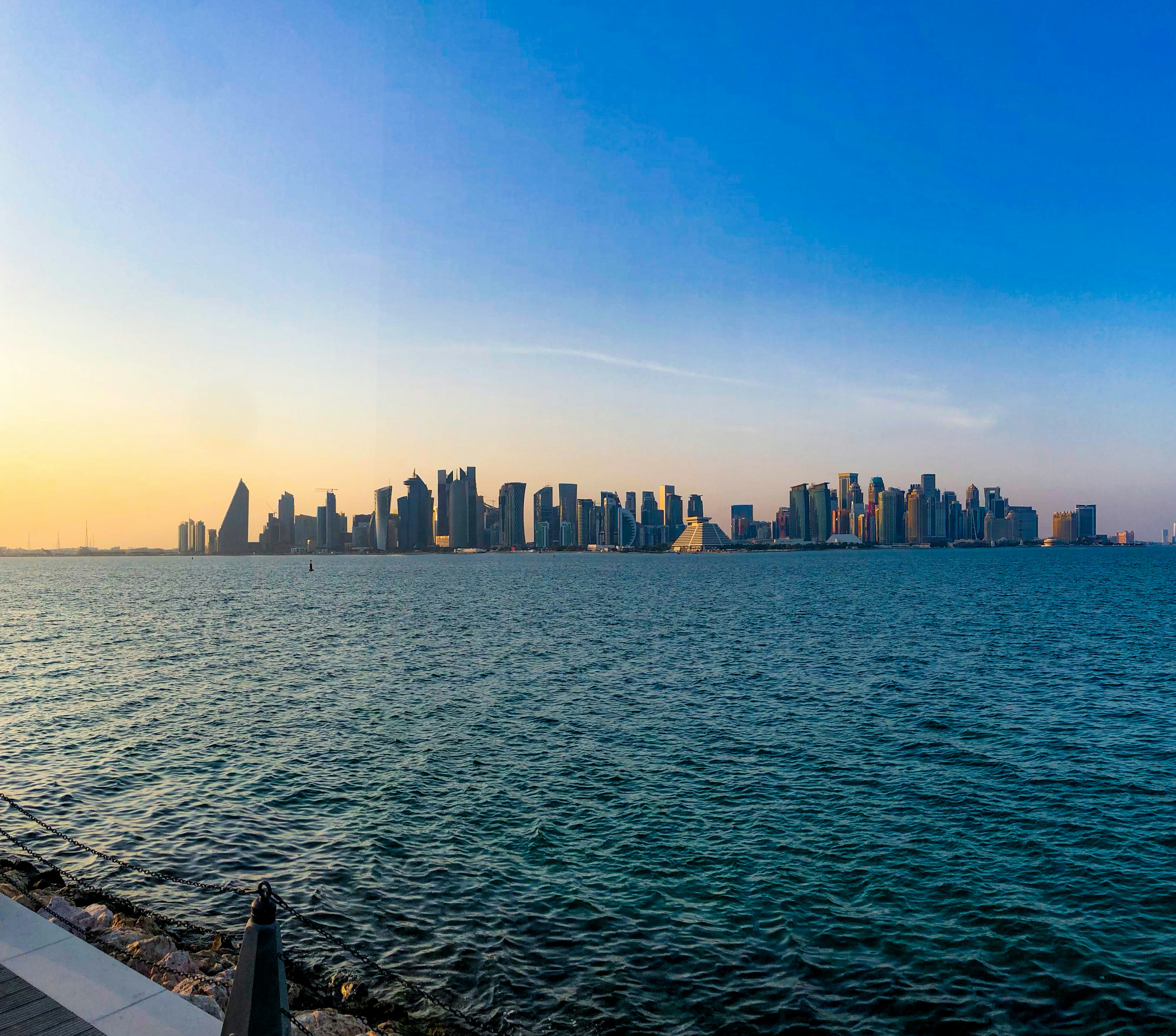 a large body of water with a city in the background