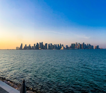 a large body of water with a city in the background