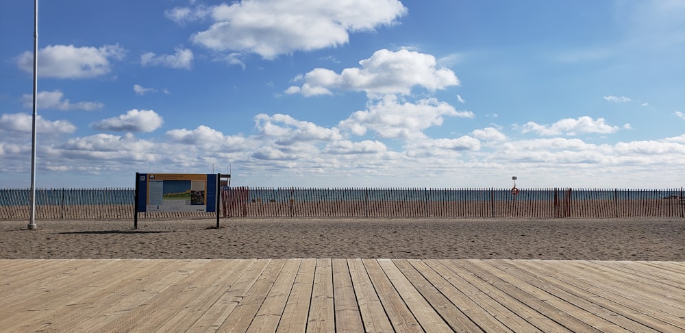 a beach with a wooden floor and a fence