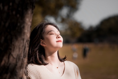 Hamida Osmanova enjoying a peaceful moment in a sunlit Italian park