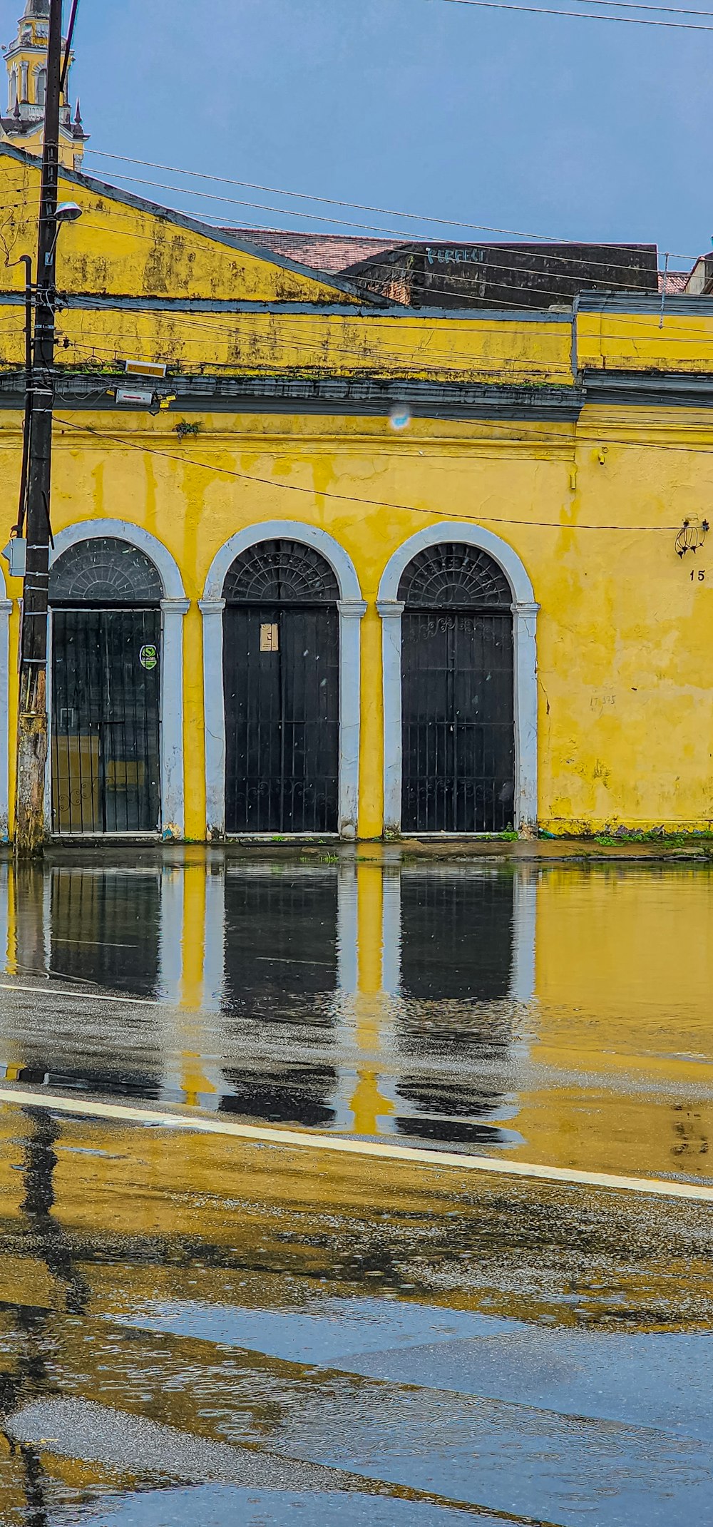 a yellow building with black doors and windows