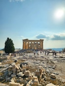 a group of people standing around a stone structure