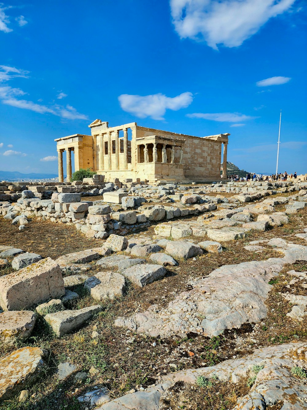 a large building sitting on top of a rocky field