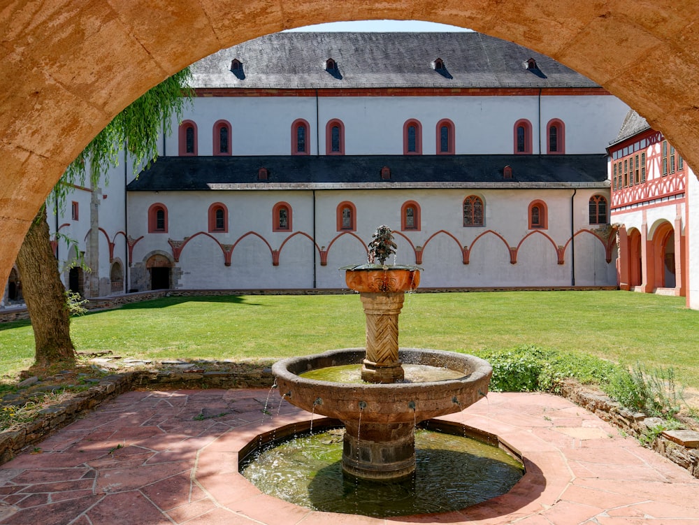 a large building with a fountain in the middle of it