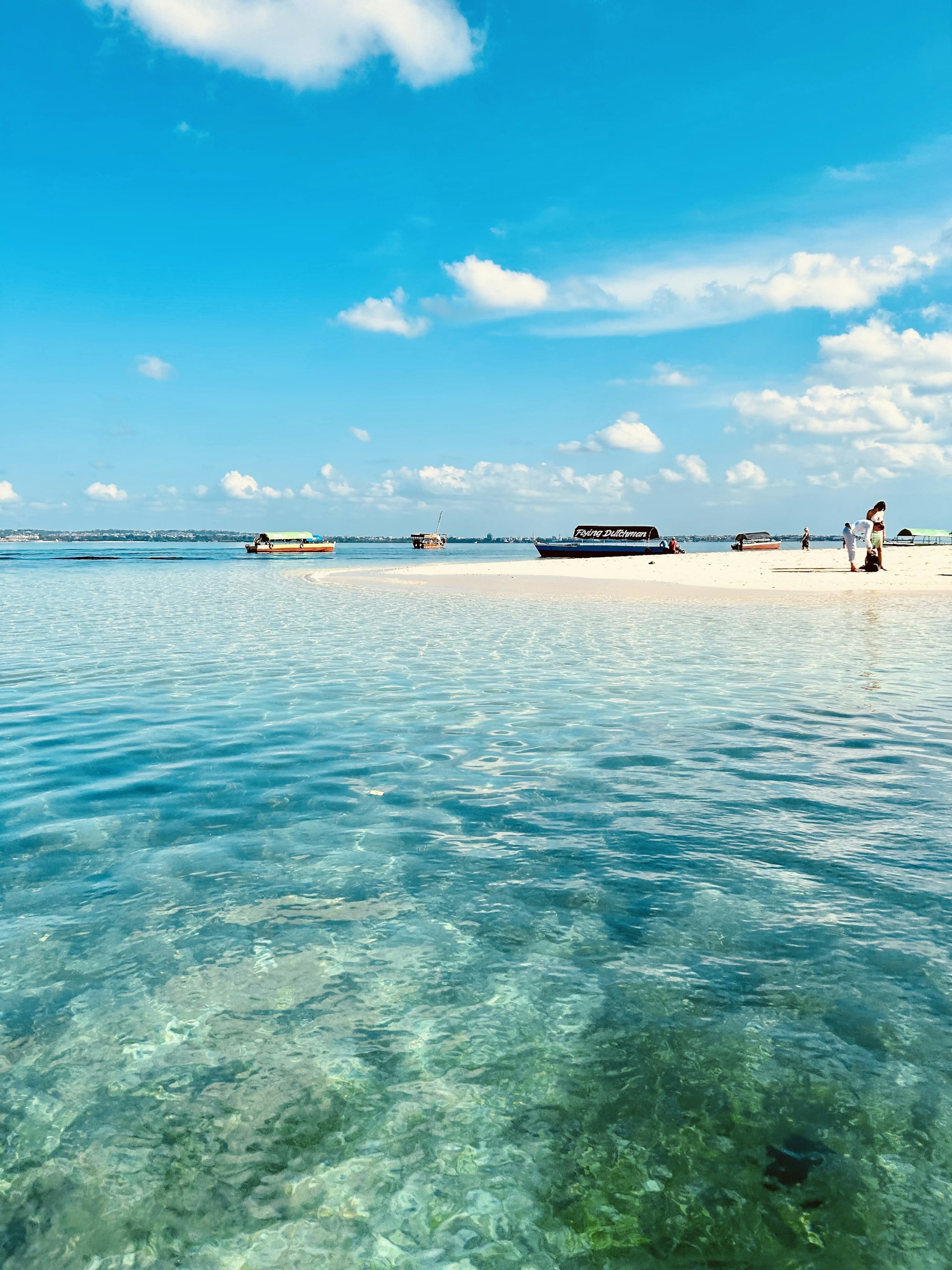 a group of boats floating on top of a body of water