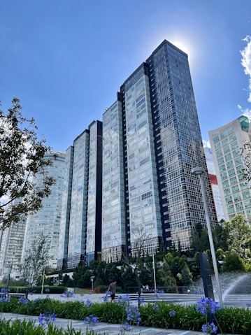 a tall building with a fountain in front of it