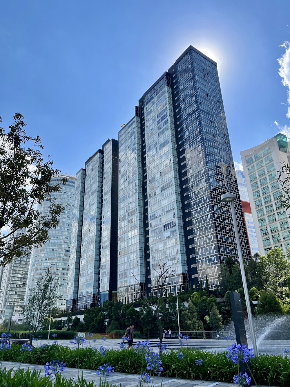 a tall building with a fountain in front of it