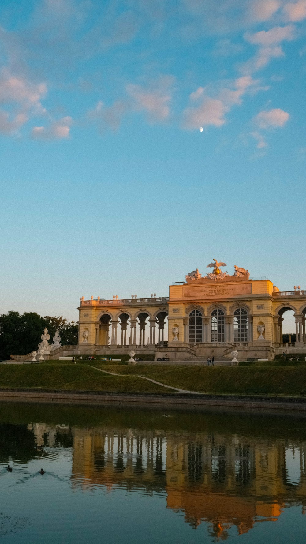 a large building sitting next to a body of water