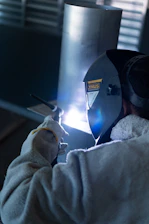 a man welding a piece of metal on a machine