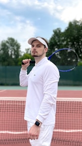 a man holding a tennis racquet on a tennis court