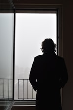 a man standing in front of a window