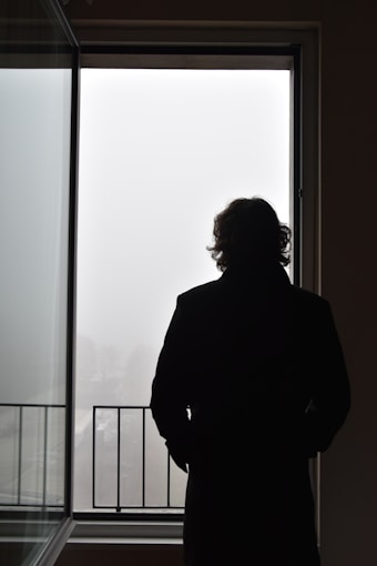 a man standing in front of a window