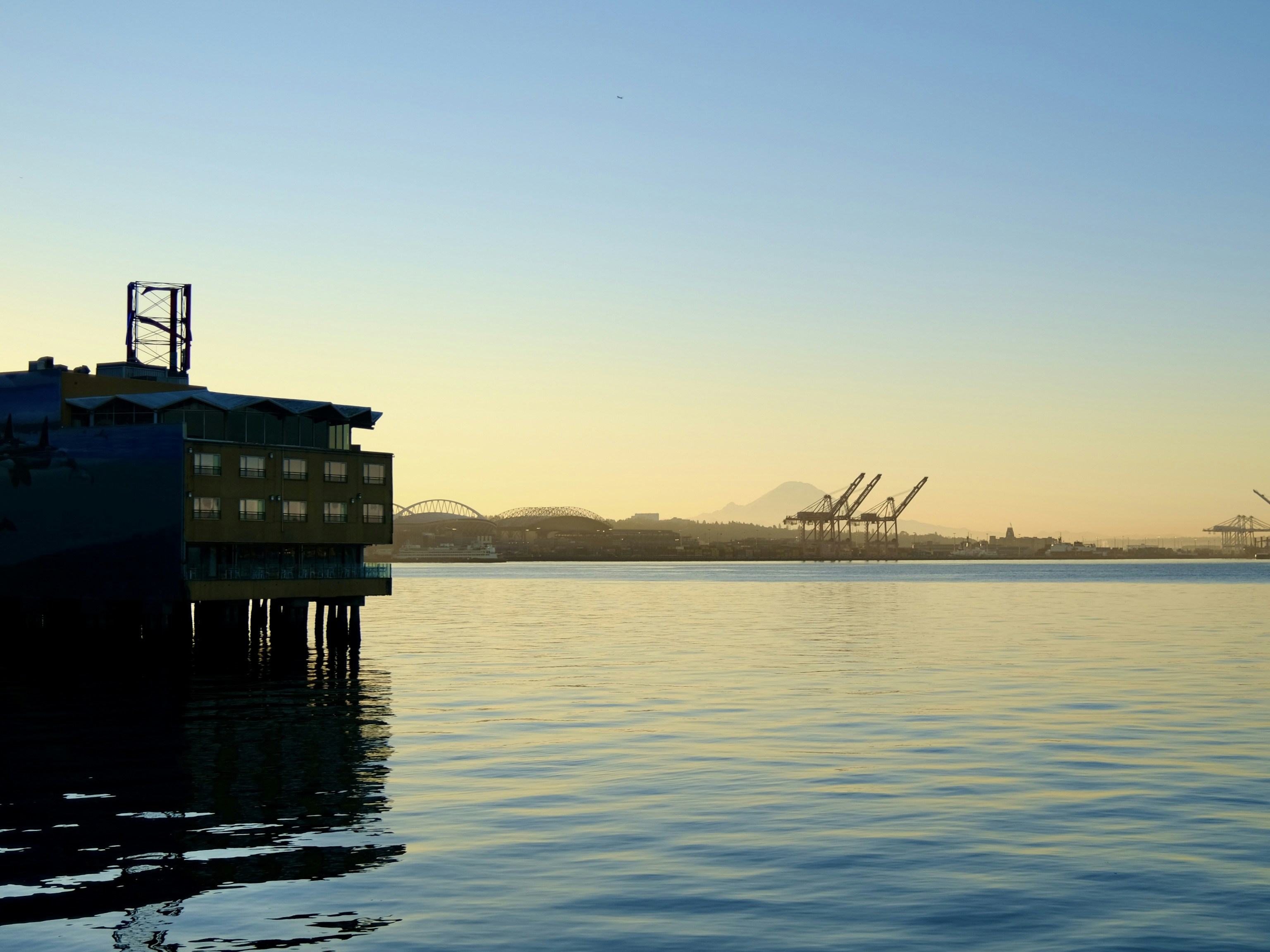 a large body of water with a boat in the distance