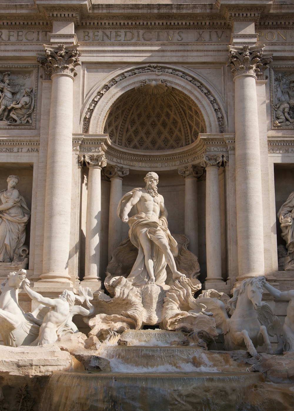 a fountain with a statue in front of it