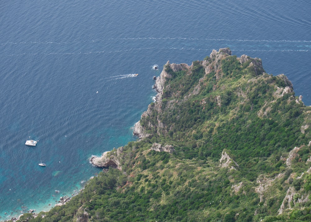 a boat is in the water near a mountain