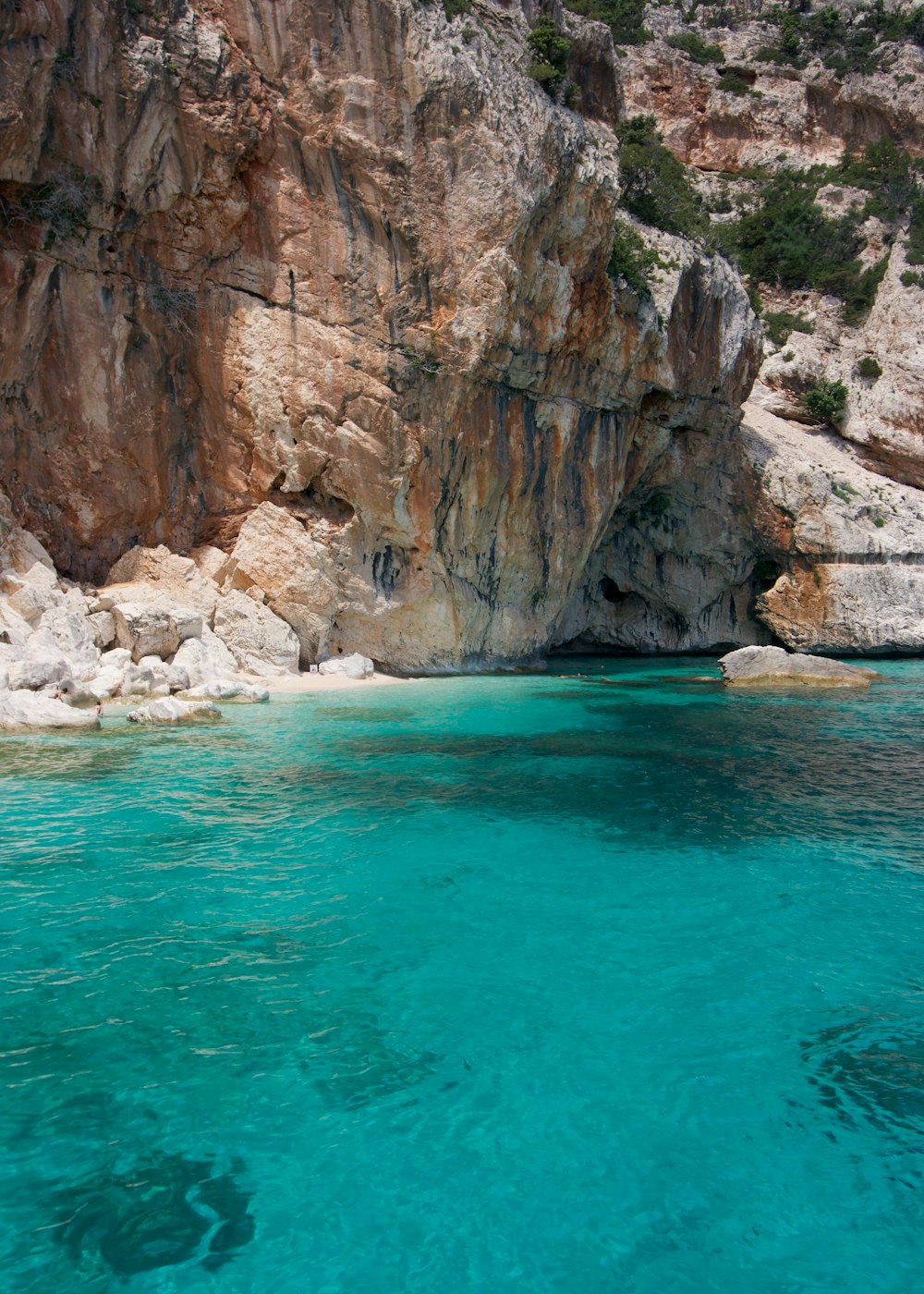 a body of water near a rocky cliff