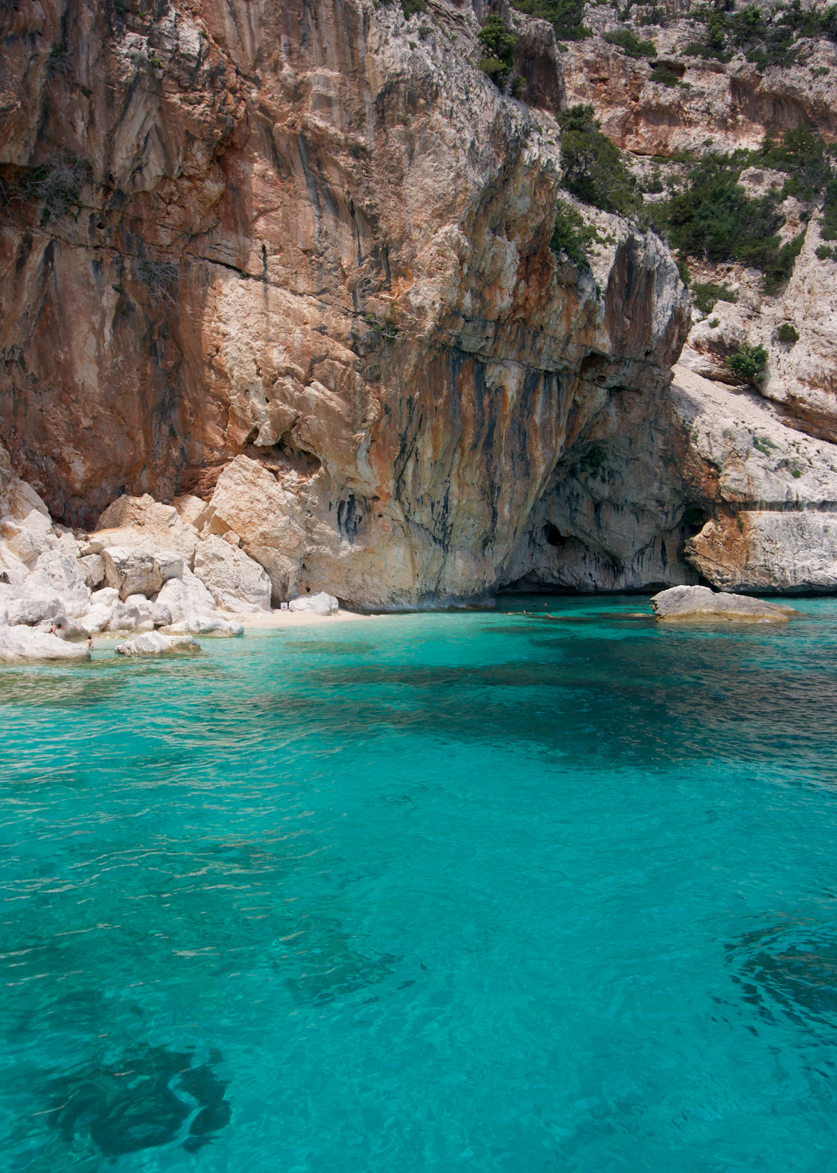 Clear water by a rocky cliff in Sardinia