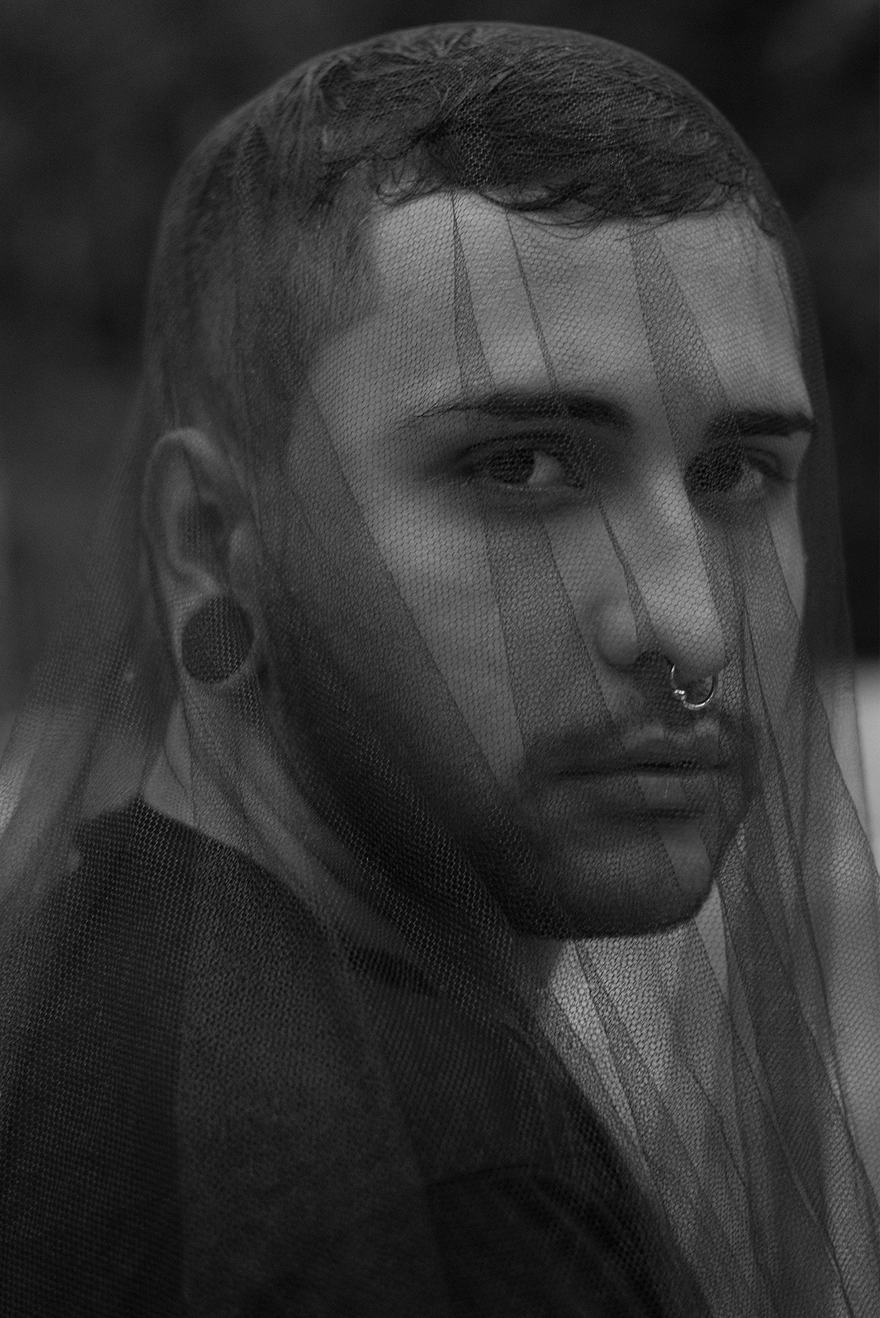 a black and white photo of a man wearing a veil