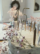 a cake with candles and flowers on a table