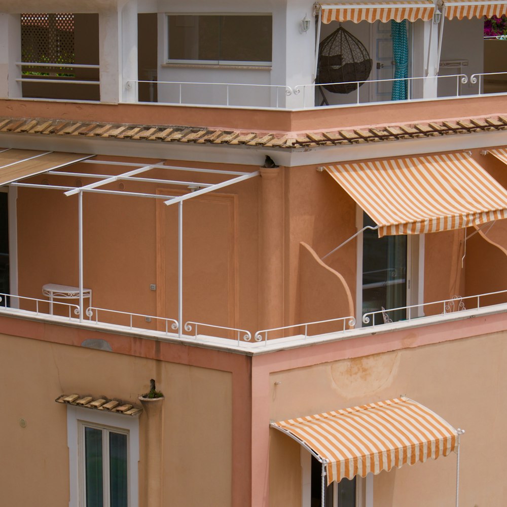 a building with two balconies and an awning