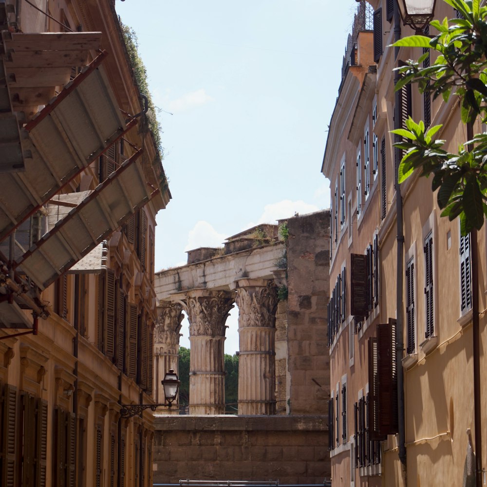 a narrow street with old buildings in the background