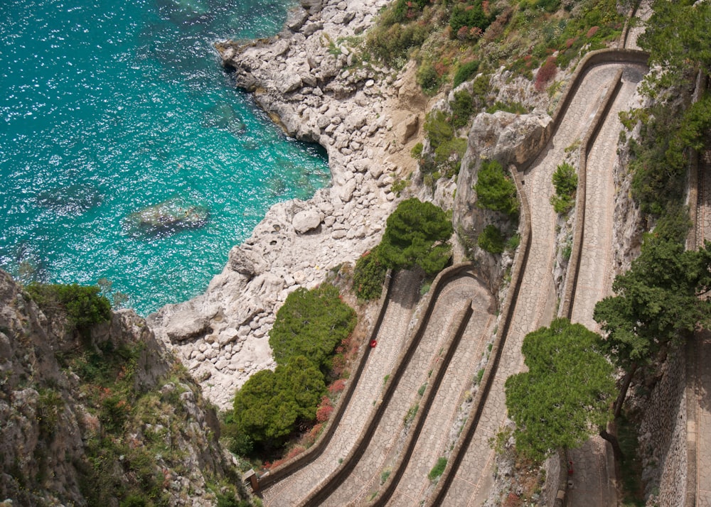 a train track next to a body of water