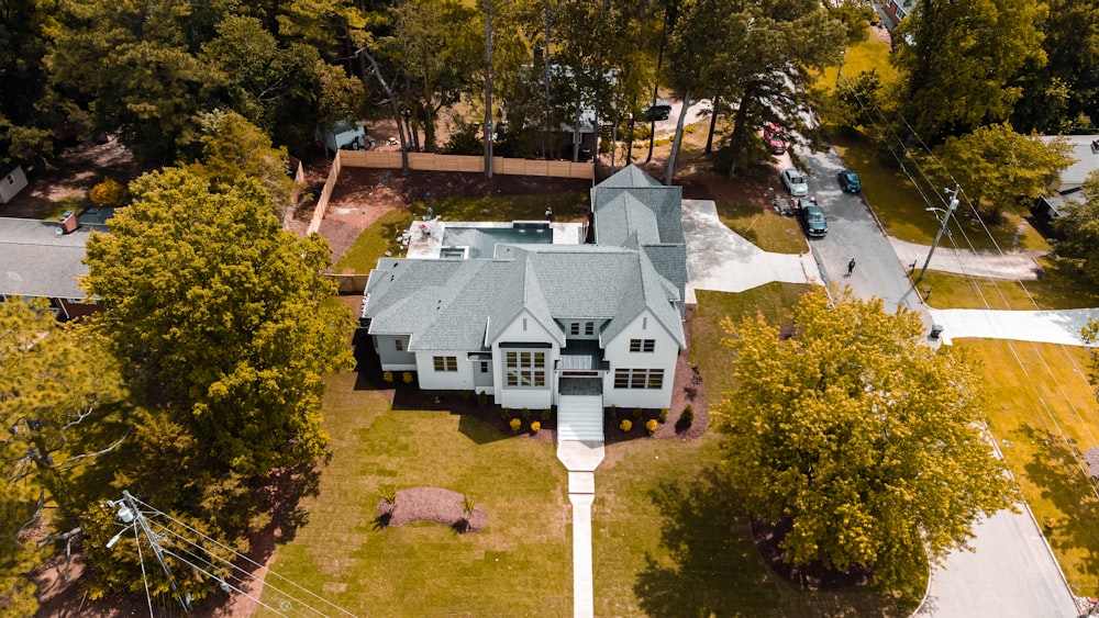 an aerial view of a large house surrounded by trees