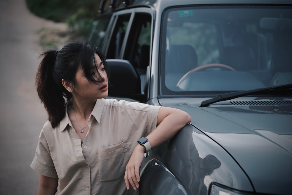 a woman leaning on the side of a truck