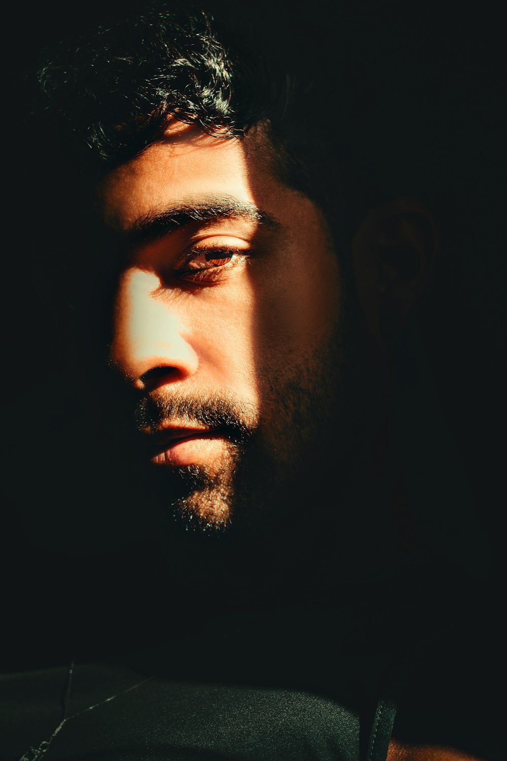 a close up of a man's face in the dark