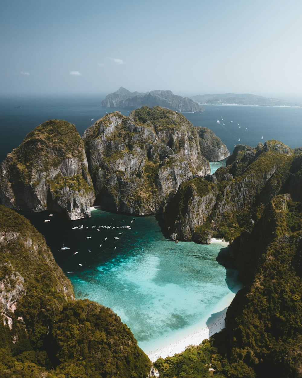 an aerial view of a lagoon surrounded by mountains