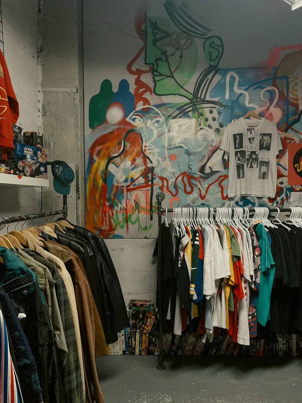 a room with a bunch of shirts hanging on a rack