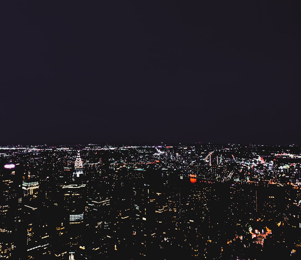 a view of a city at night from the top of a building