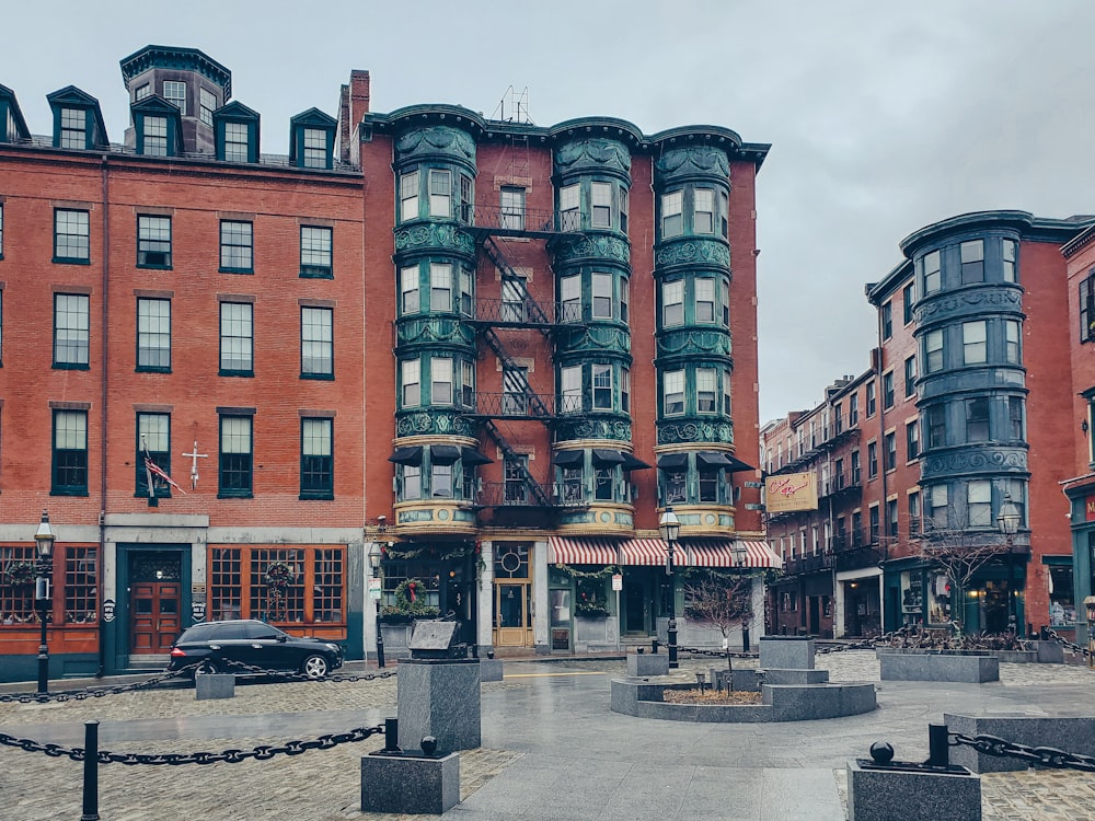 a group of buildings with a car parked in front of them